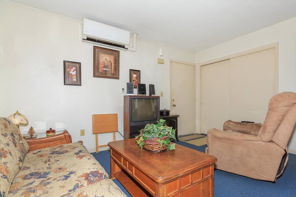 a living room filled with furniture and a bed