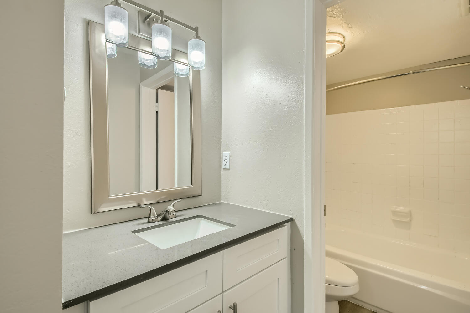 Rise at the Palms apartment bathroom with a quartz countertop and a tub in a separate room. 