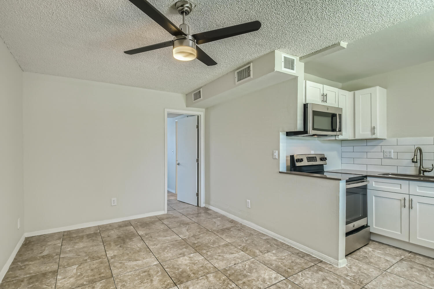 The tiled dining area near the kitchen at a Rise at the Palms apartment. 