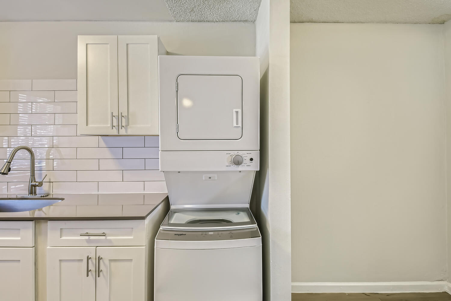A kitchen at Rise at the Palms with a washer and dryer. 