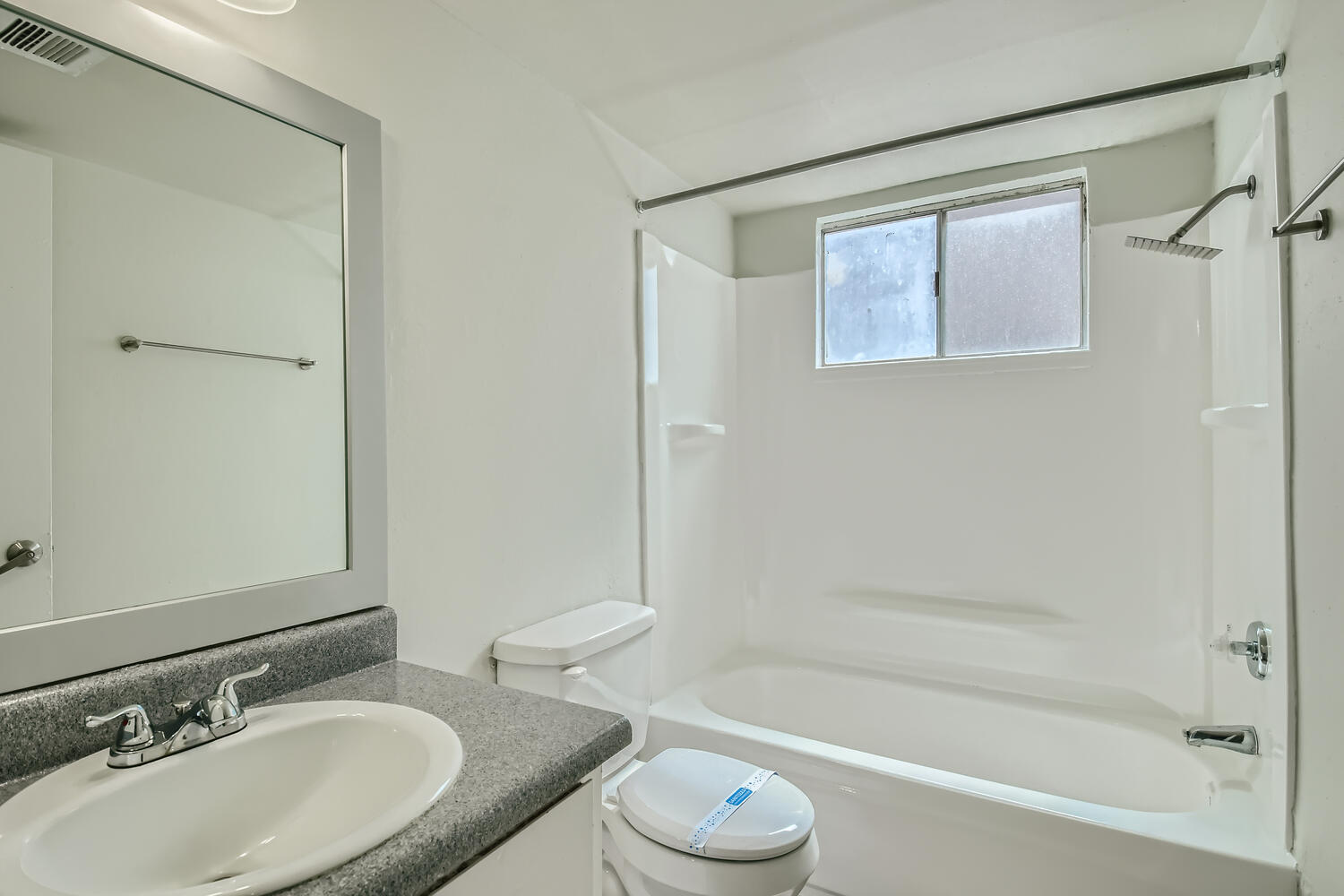 A bathroom with a tub and a vanity at Rise at the Palms. 