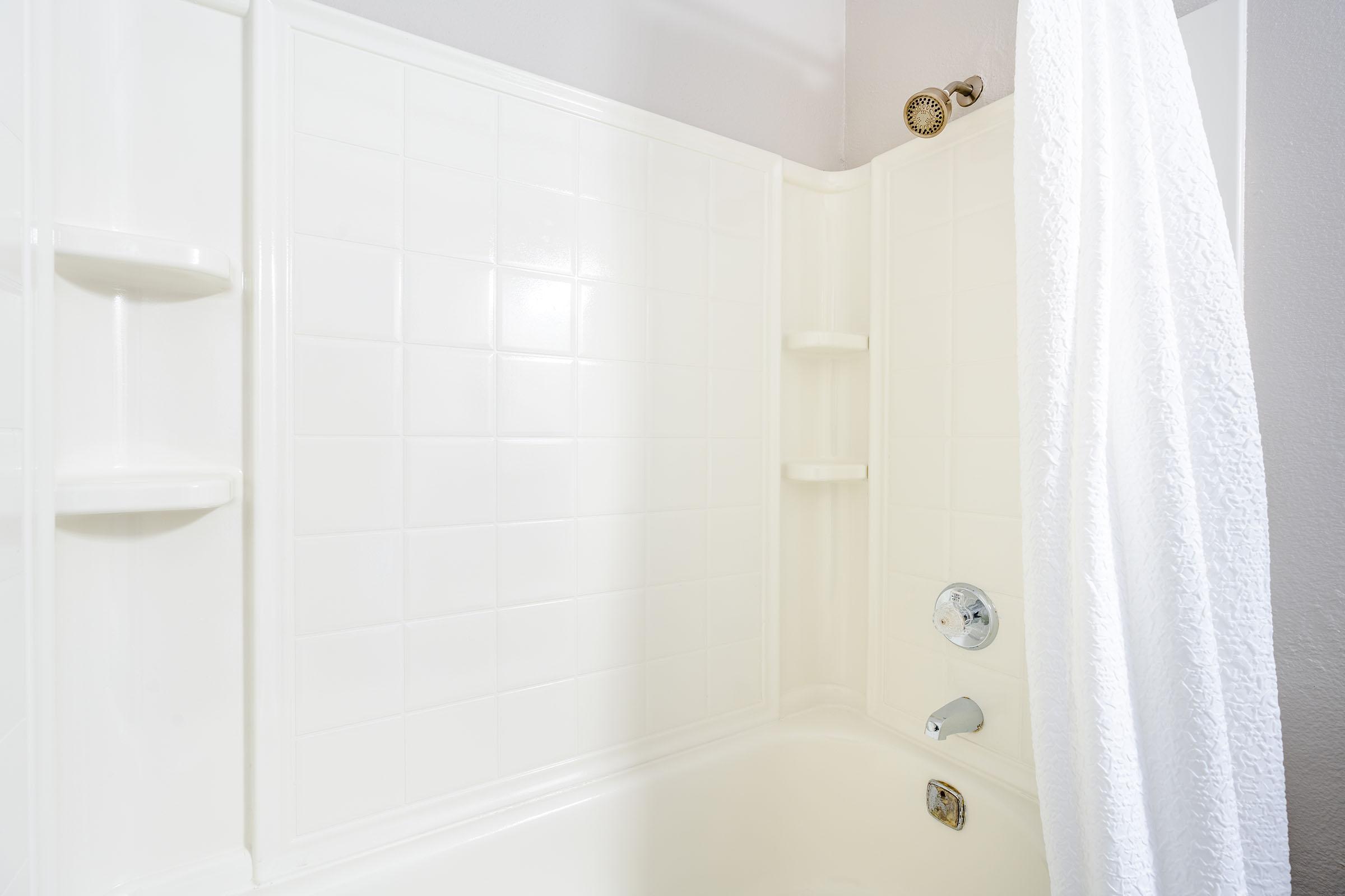 Clean white shower and open shower curtain