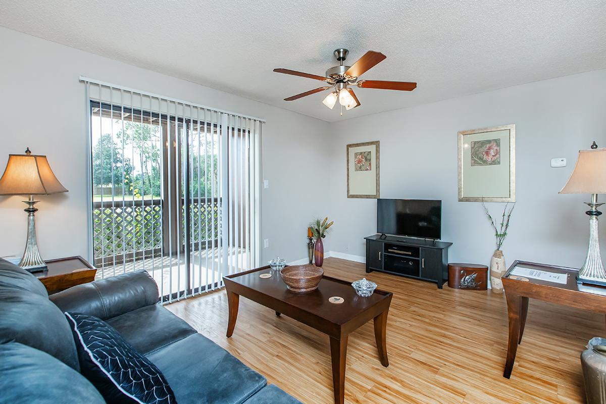 a living room filled with furniture and a flat screen tv