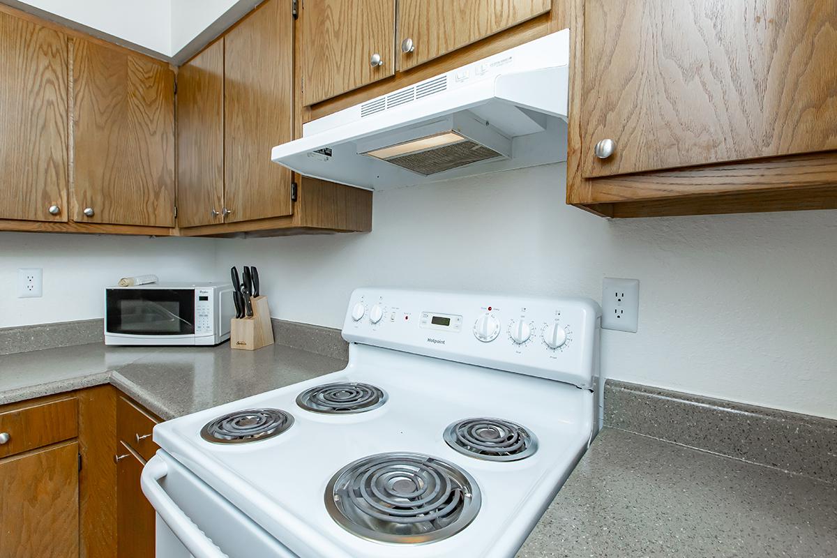 a white stove top oven sitting inside of a kitchen