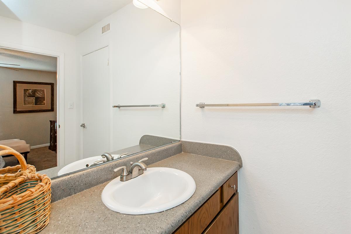 a room with a sink and a mirror