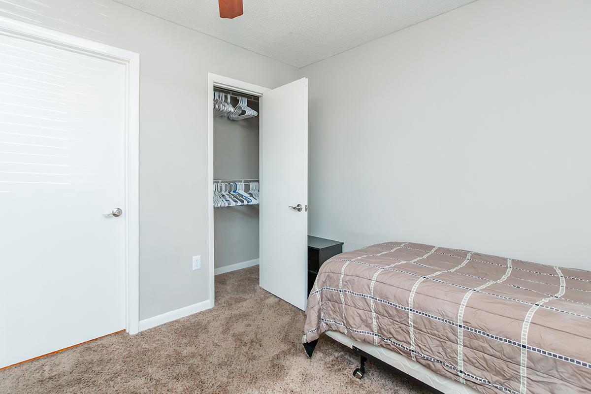 a bedroom with a bed in a room