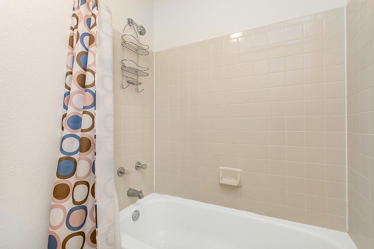 a white tub sitting next to a shower