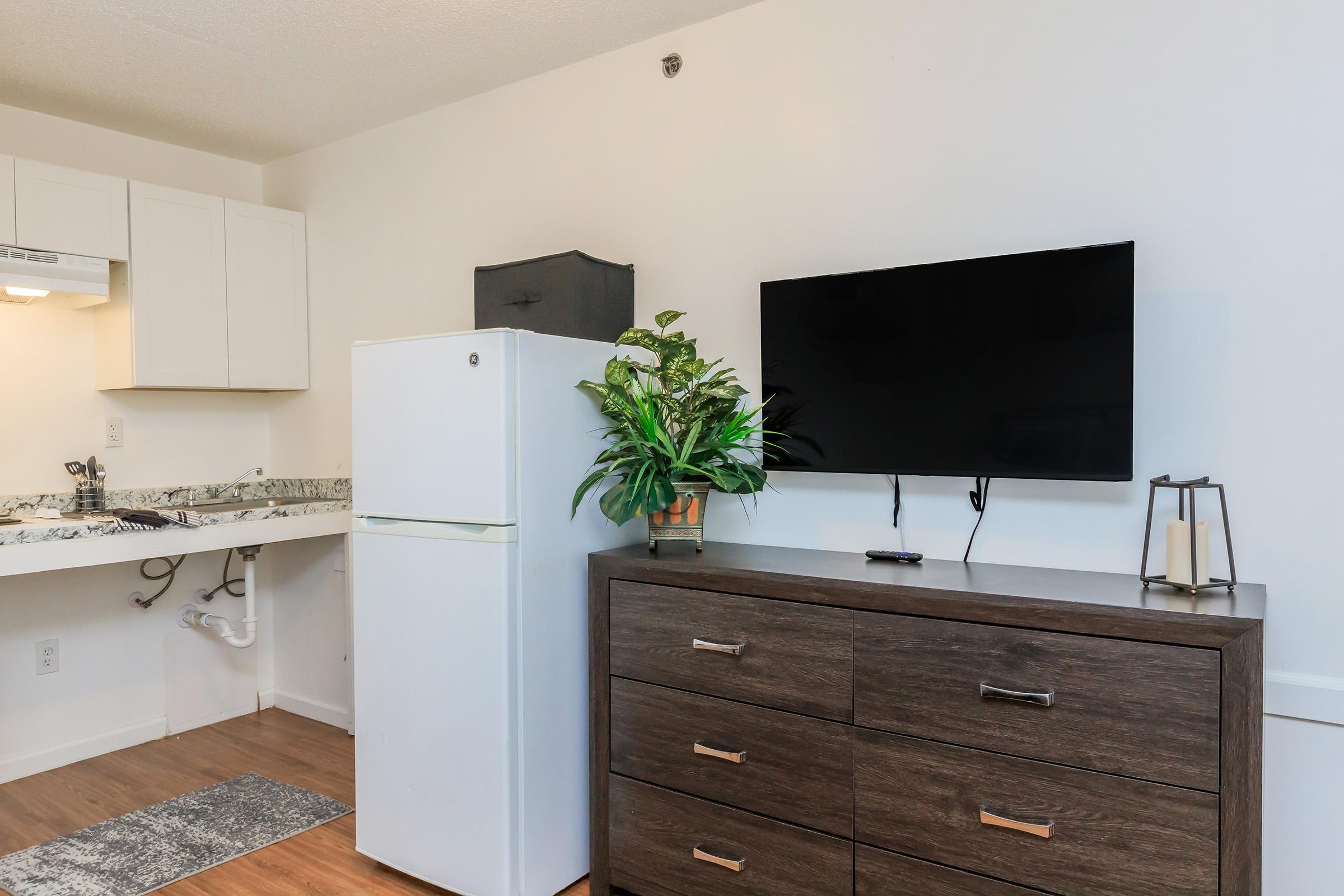 a kitchen with a stove top oven sitting inside of a room