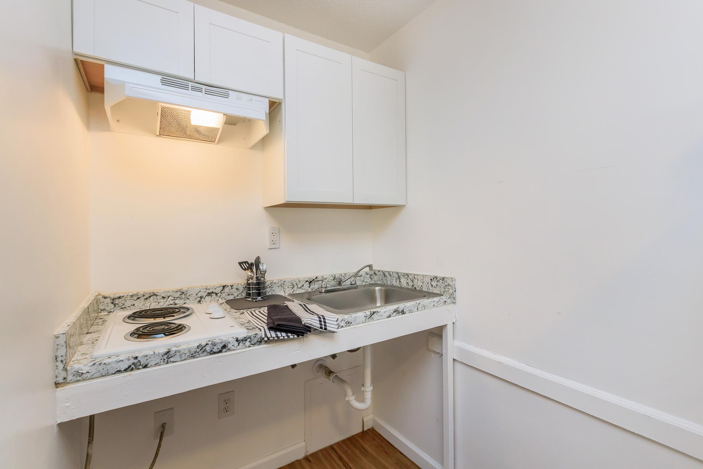 a kitchen with a sink and a mirror