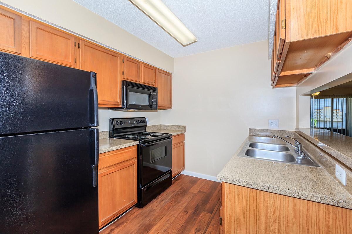 a kitchen with stainless steel appliances and wooden cabinets