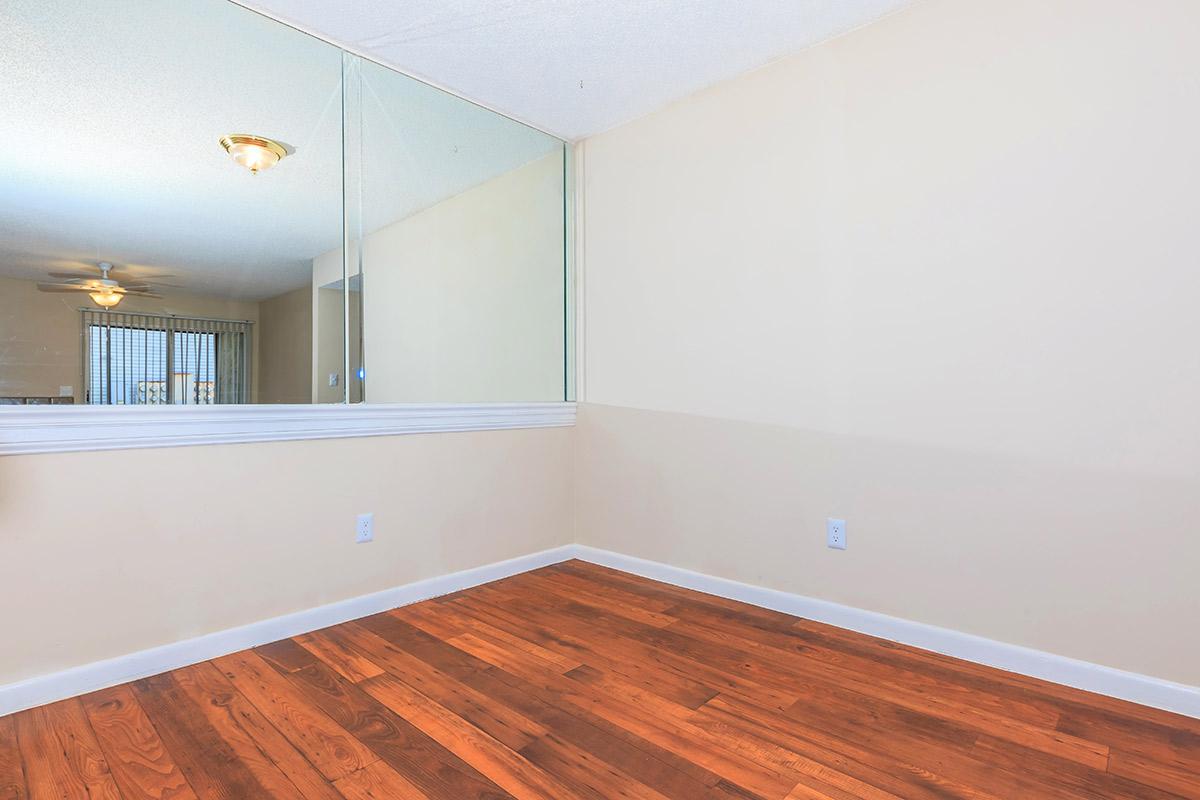 a large empty room with a wooden floor