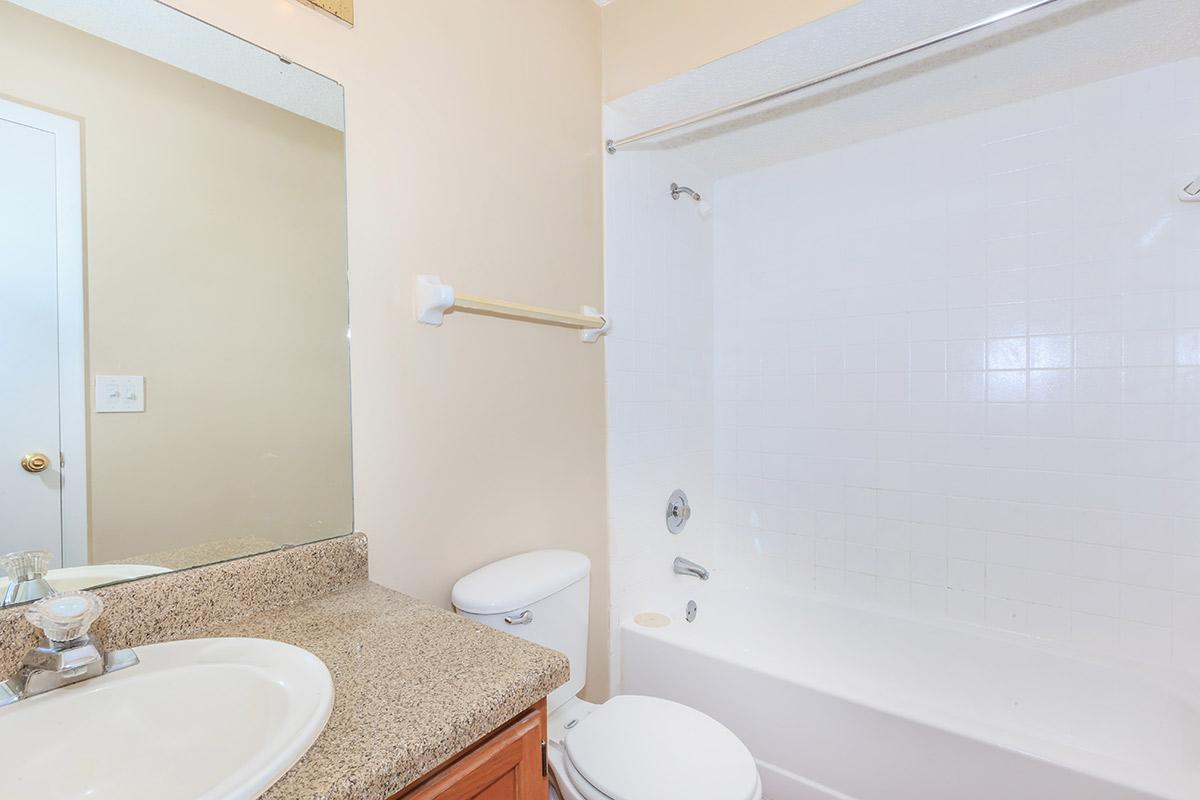 a room with a sink and a mirror