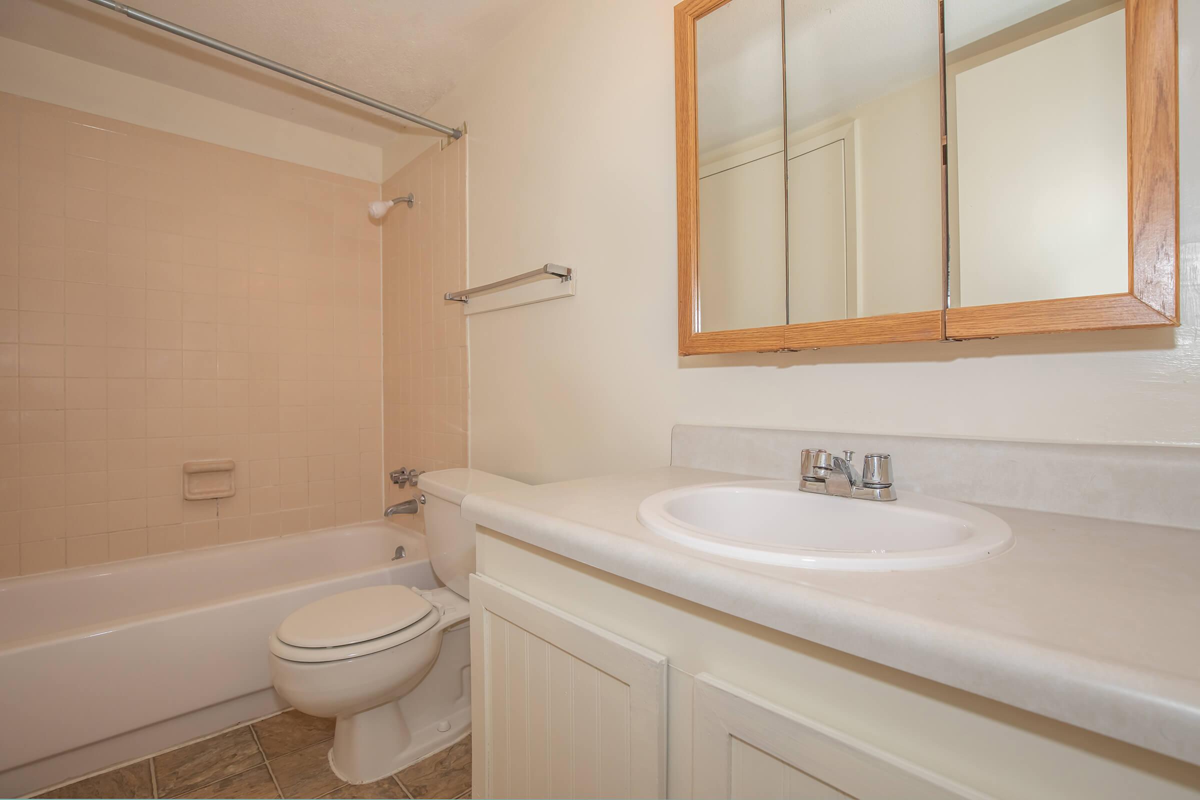 a white tub sitting next to a sink