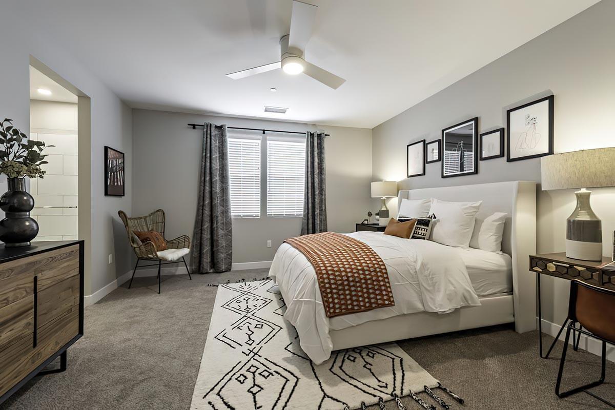 Two Bedroom Apartments In Fresno County CA - Parador Townhomes - Spacious Bedroom Featuring Ceiling Fan, Carpeting, And Window Coverings