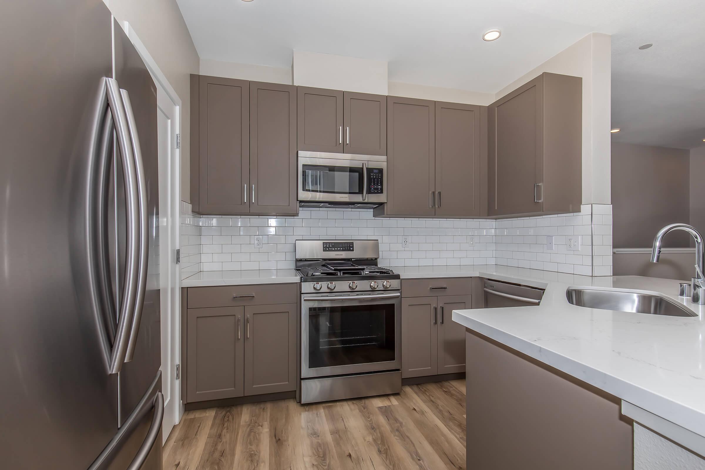 a large kitchen with stainless steel appliances