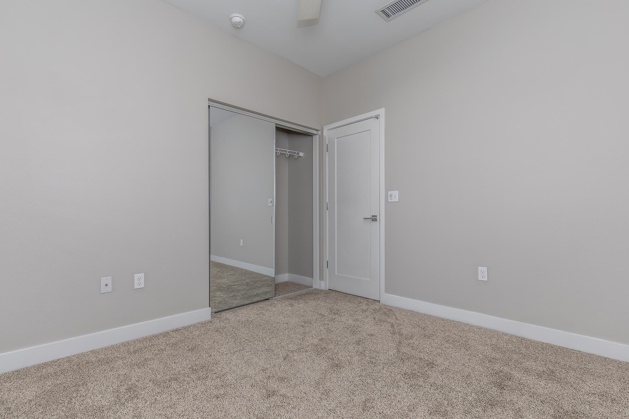 a bedroom with a large mirror