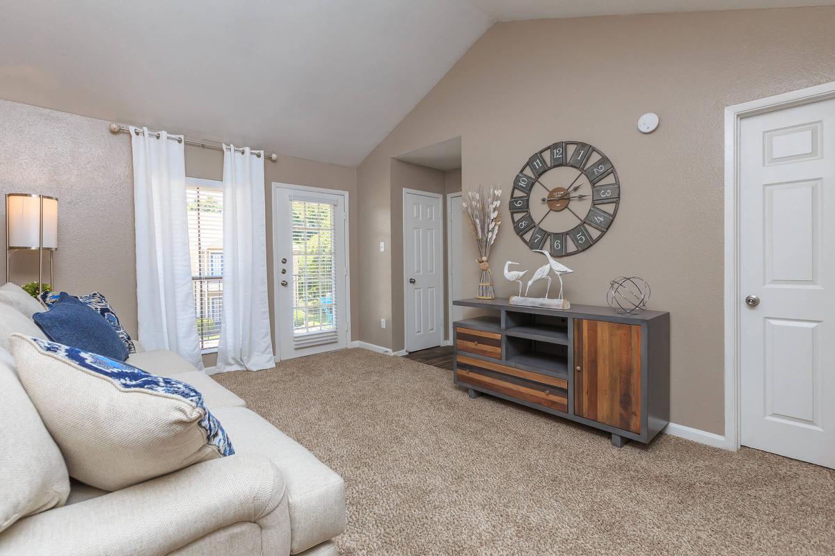 a living room filled with furniture and a large window