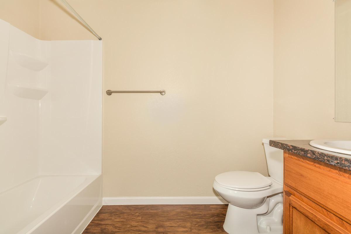 a white tub sitting next to a shower