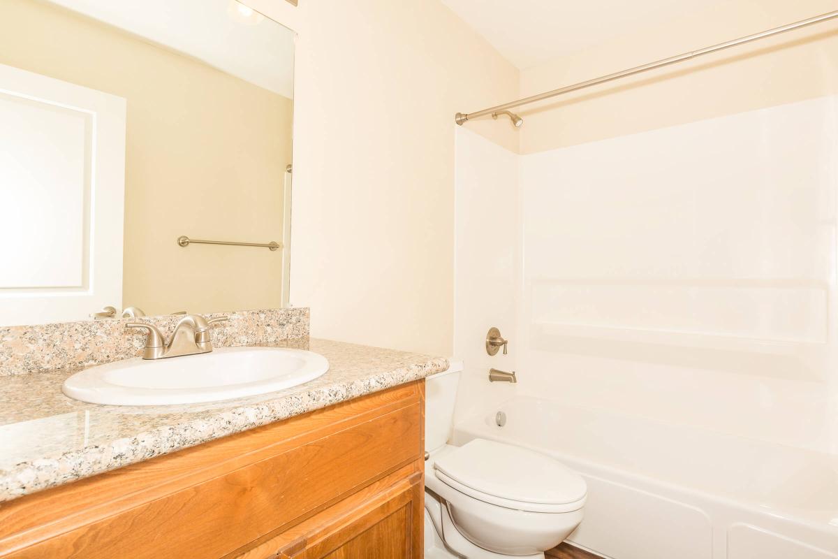 a white tub sitting next to a shower