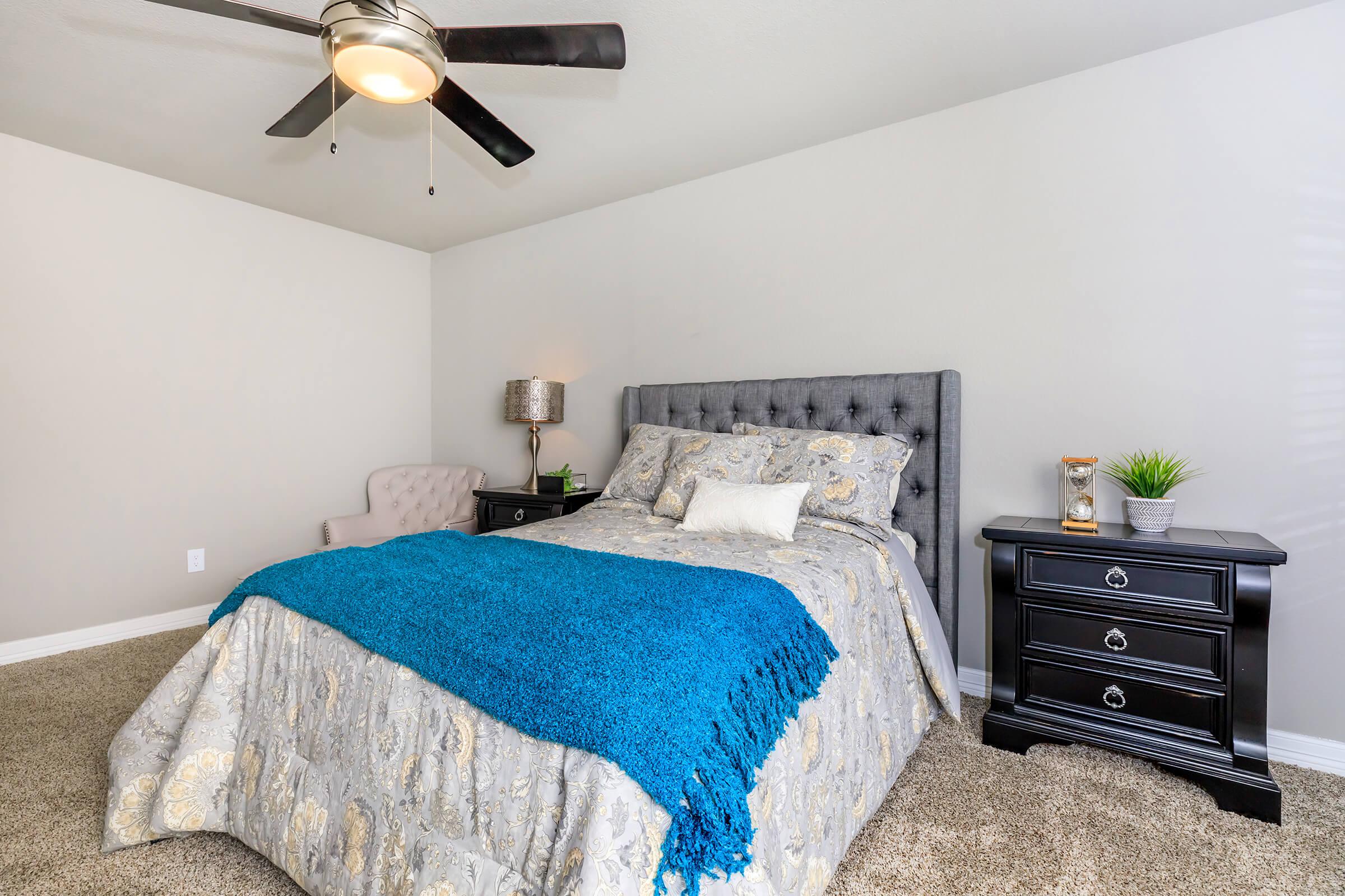 a bedroom with a bed and a blue blanket