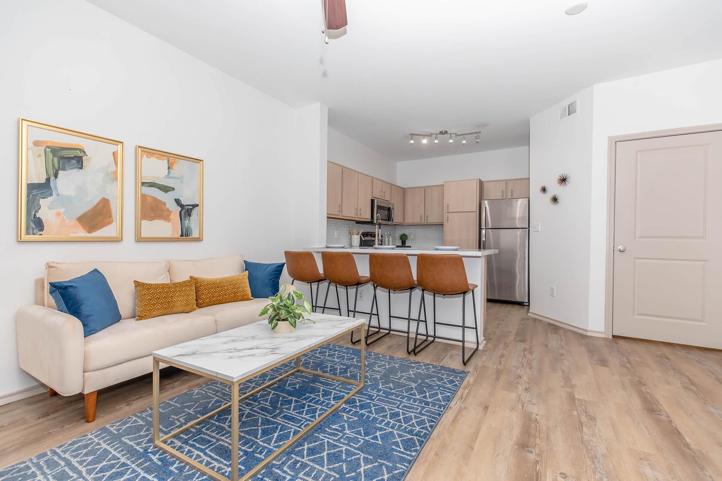 This open-concept layout makes it easy to stay connected—whether you're cooking in the kitchen, hosting friends at the bar, or lounging on the sofa. It's the perfect space for both everyday living and weekend entertaining!