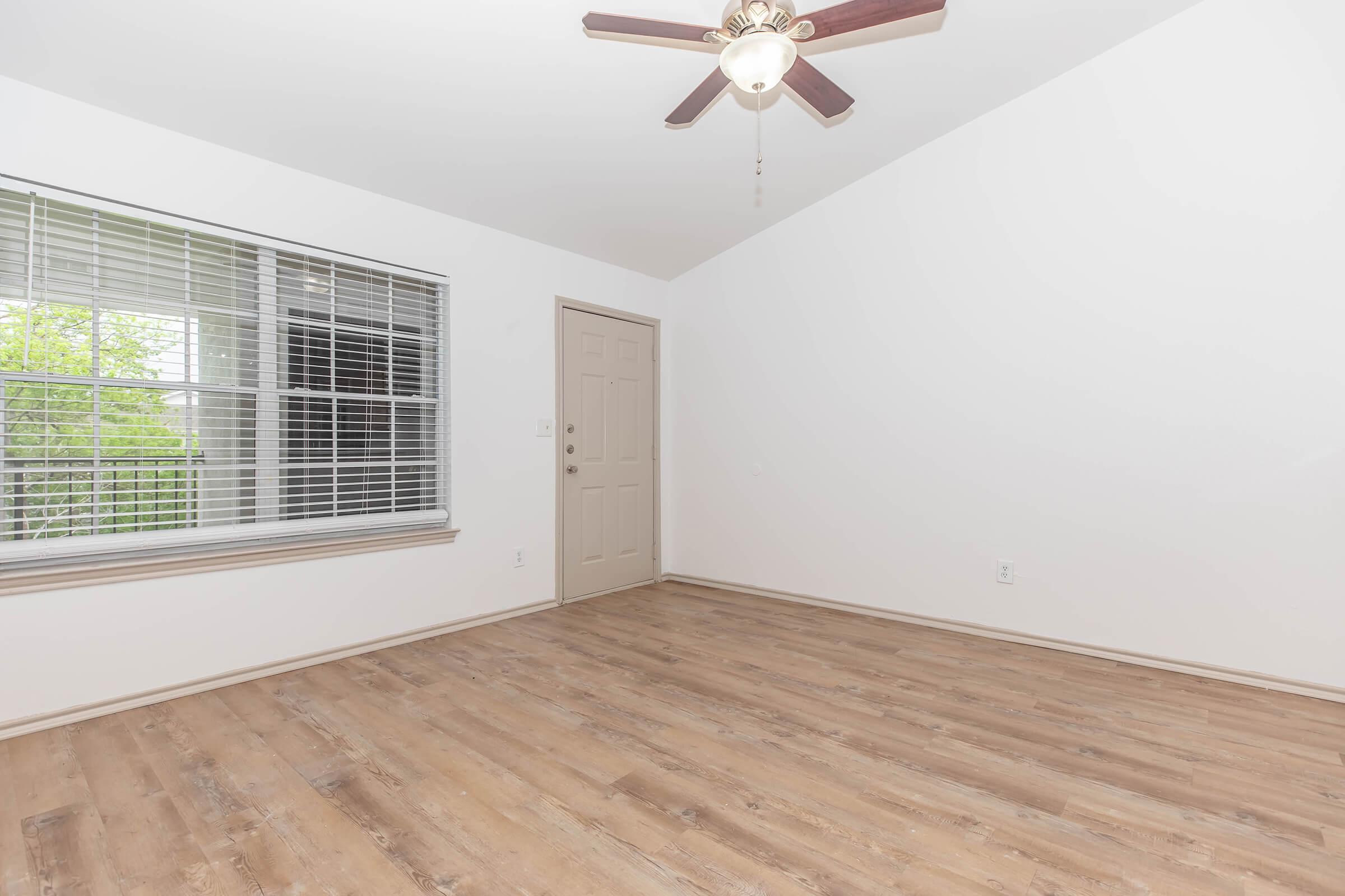 Bright Living Space with Wood-Style Floors and Ceiling Fan
