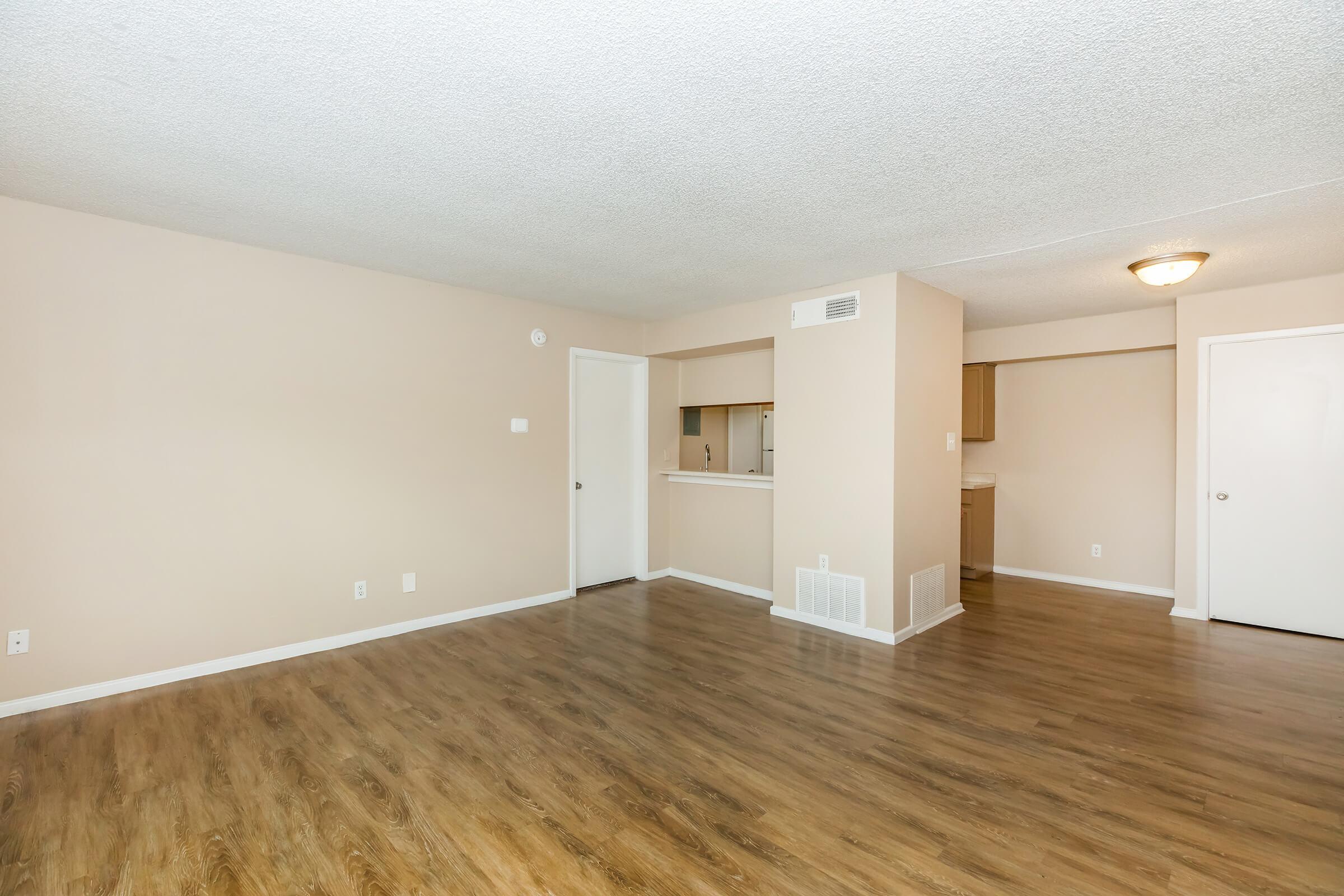 a large empty room with a wood floor