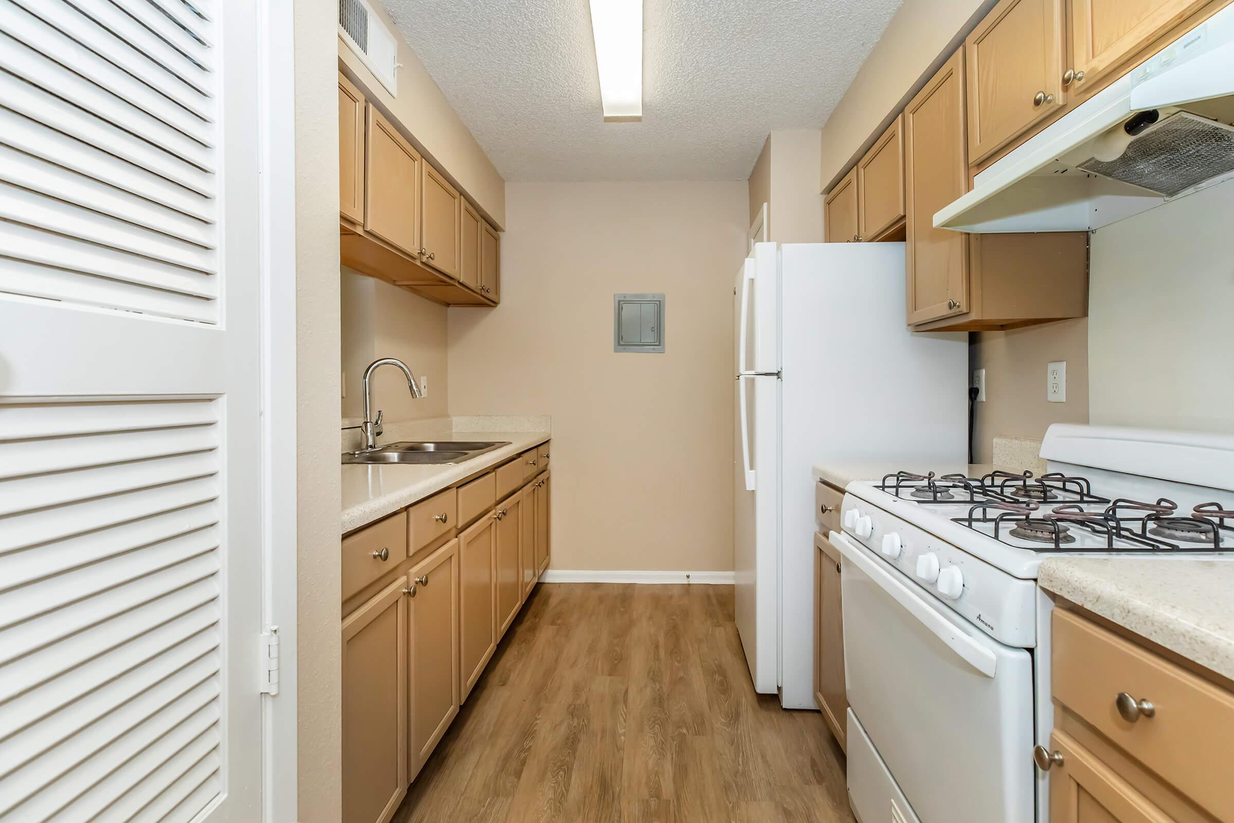 a kitchen with a stove sink and refrigerator