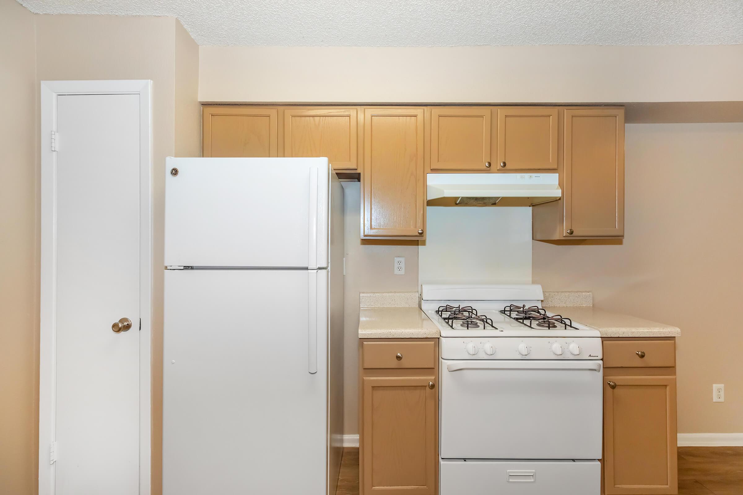 a kitchen with a stove top oven sitting inside of a refrigerator