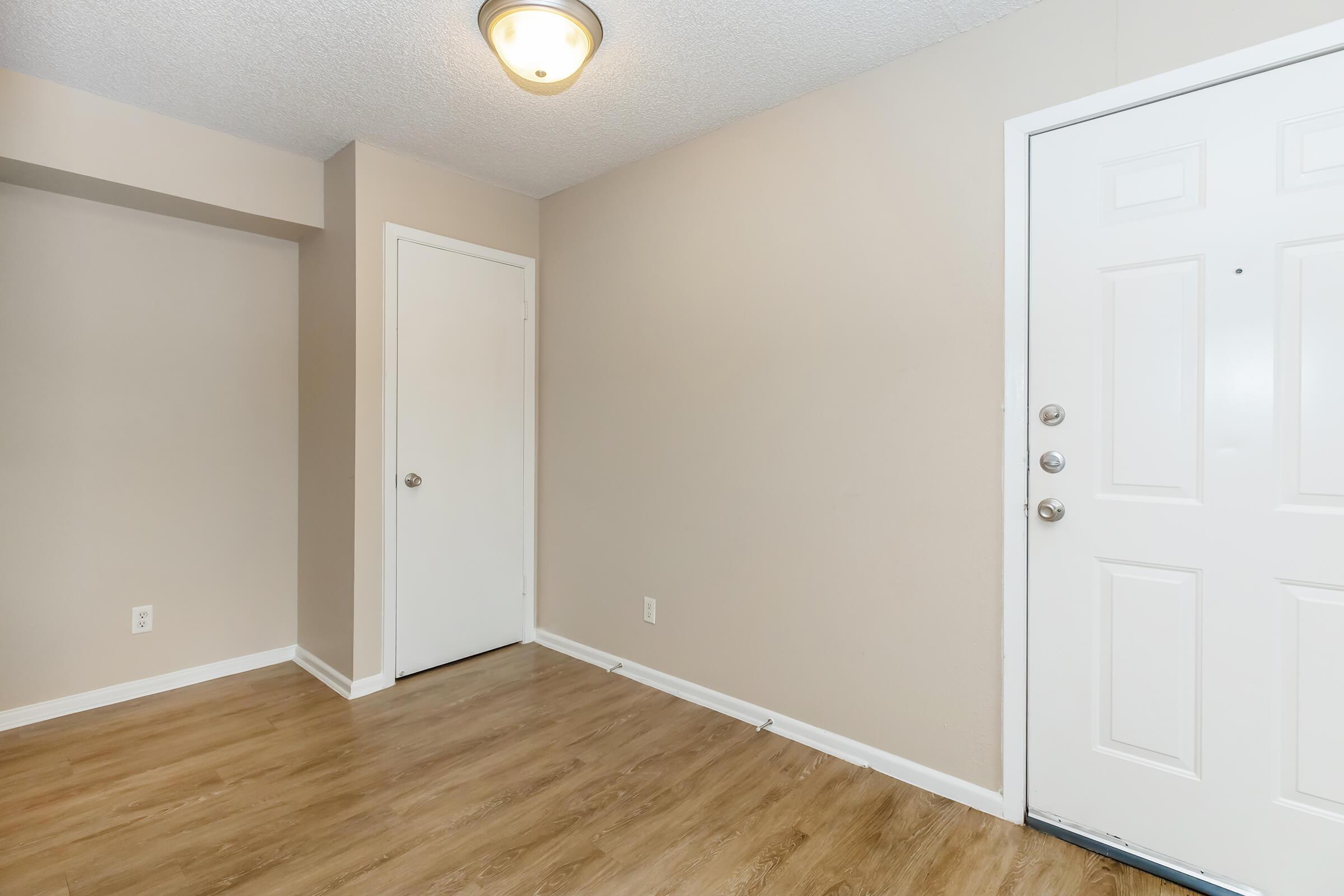 a close up of a hard wood floor next to a door