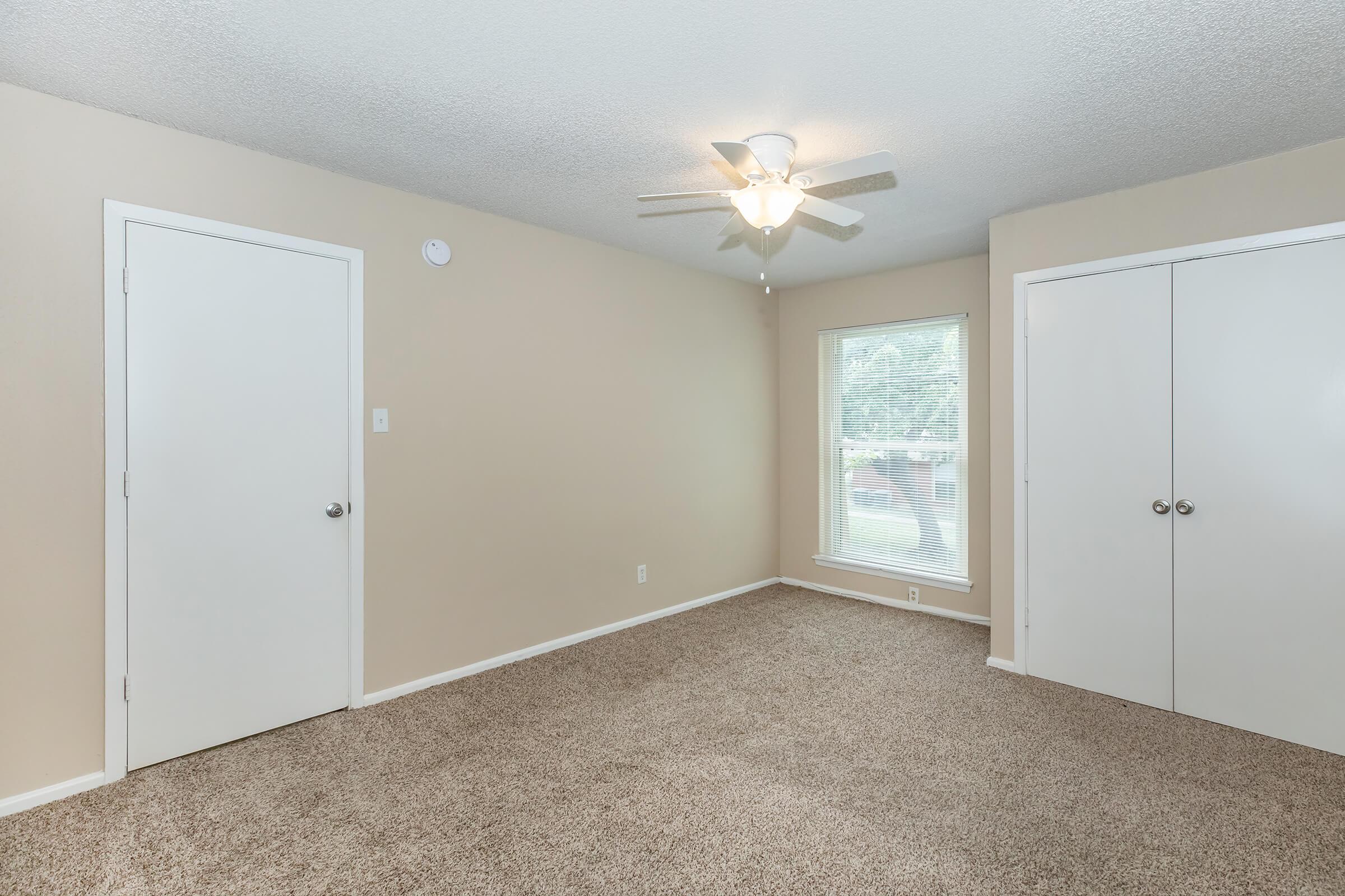 a bedroom with a large mirror