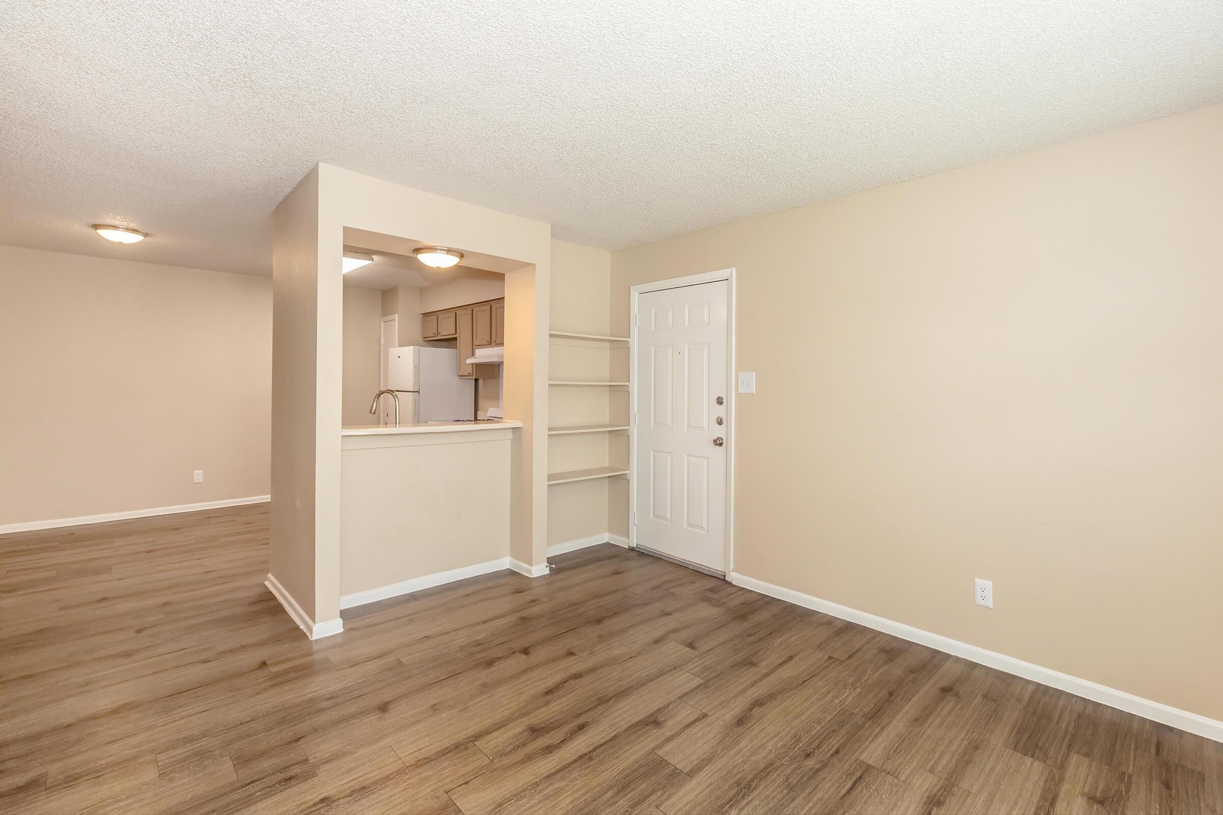 a large empty room with a wood floor