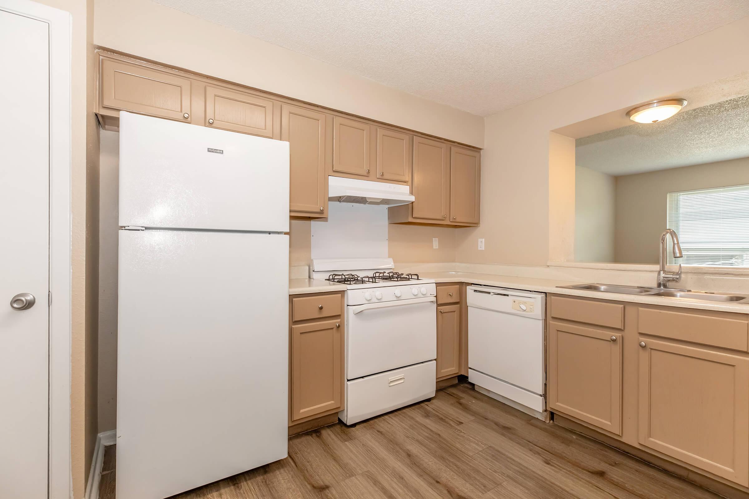 a kitchen with a stove and a refrigerator