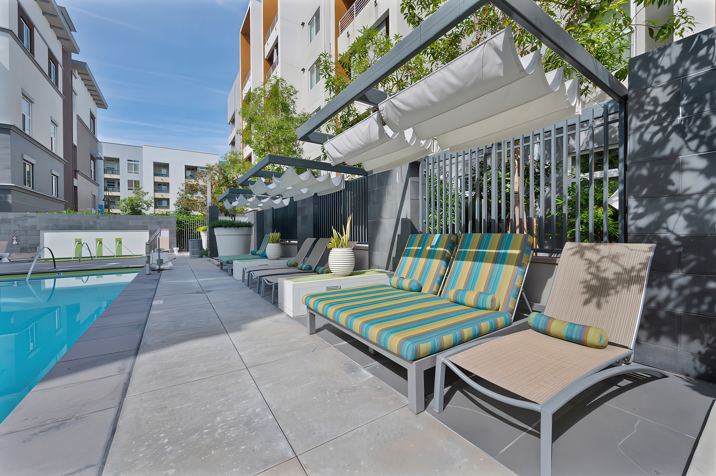 lounge chairs next to a pool