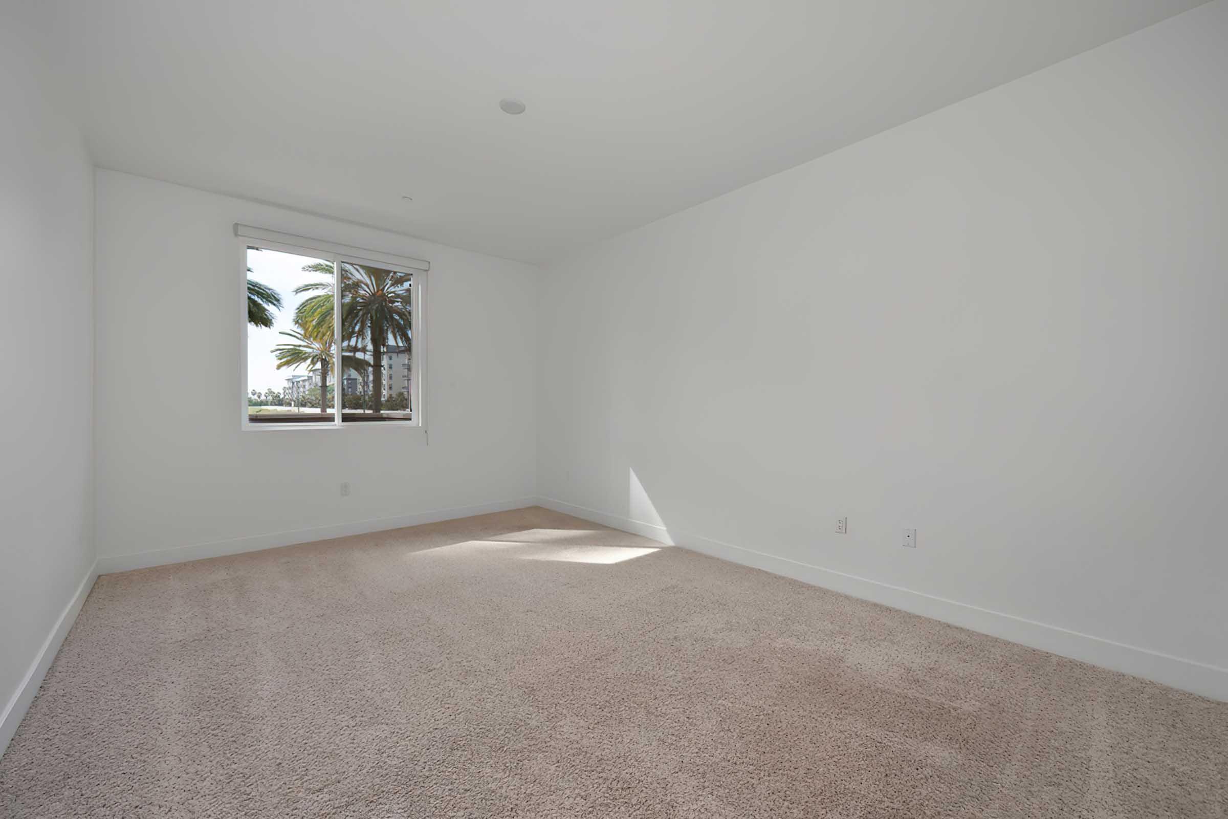 an empty room with carpeted floors