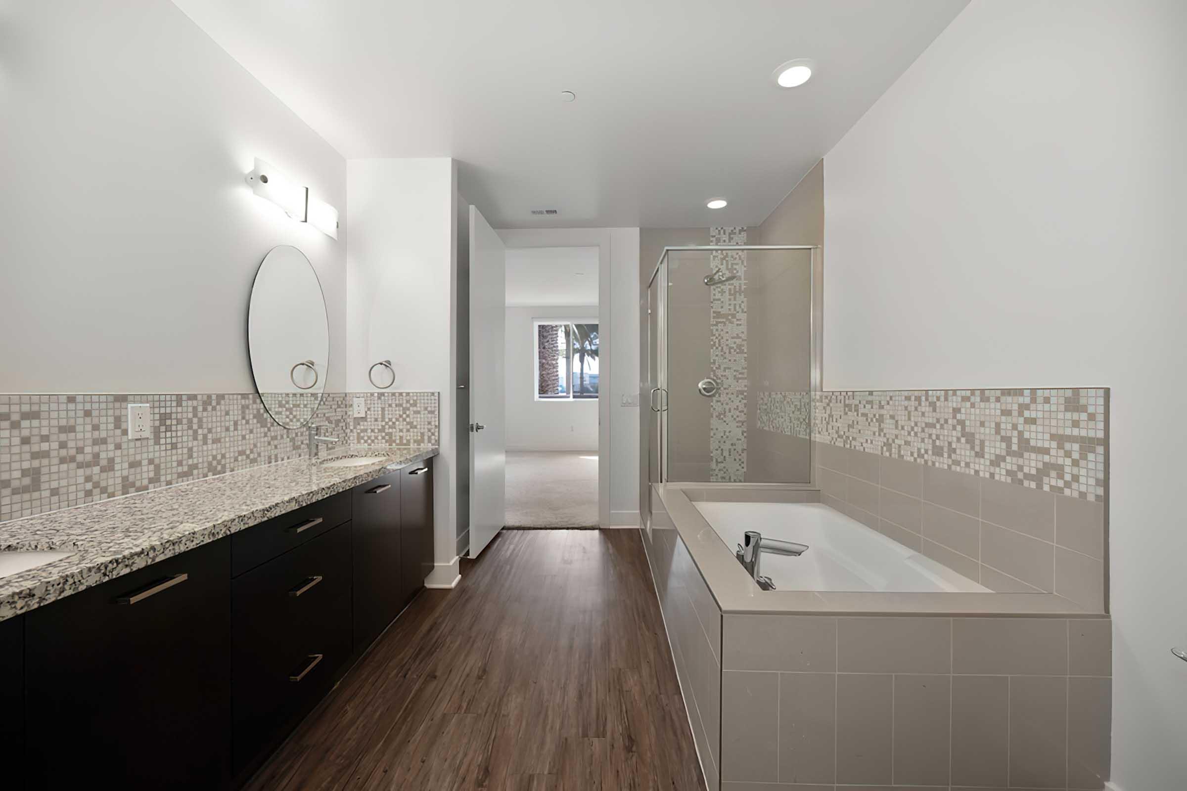 a bathroom with a round mirror