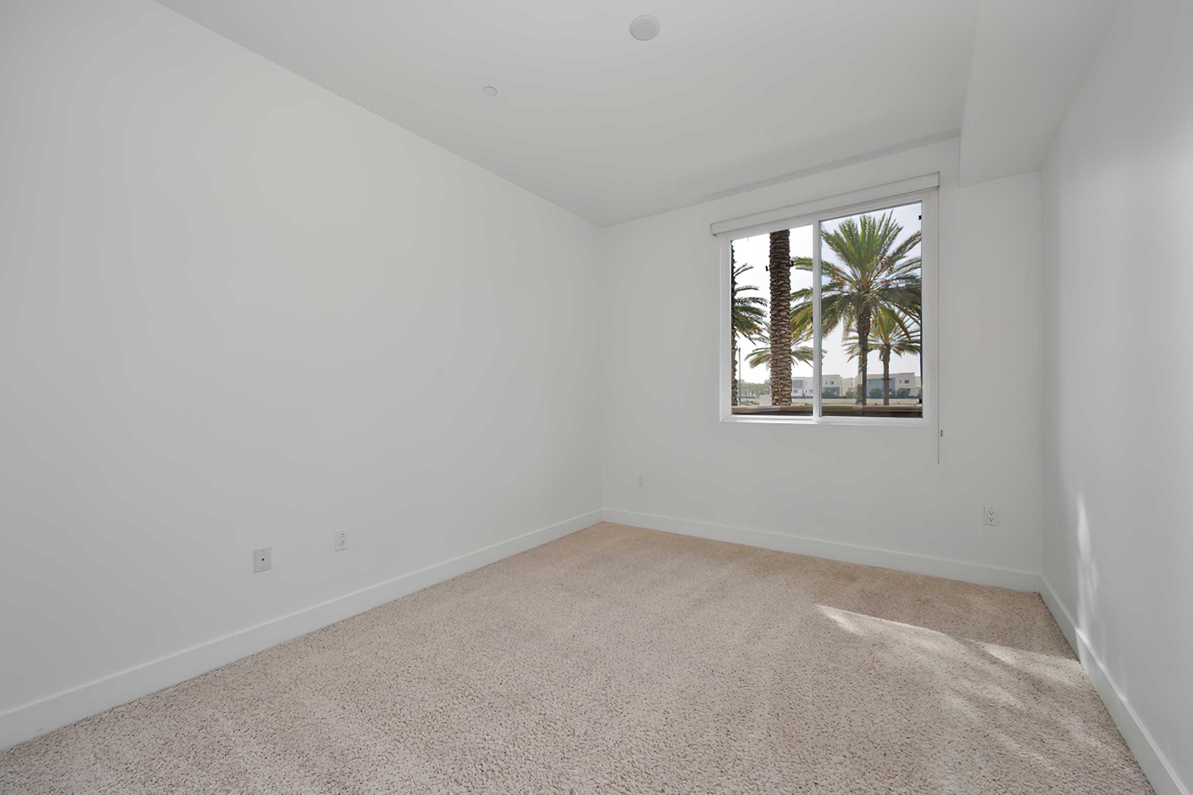 a large empty bedroom with a window