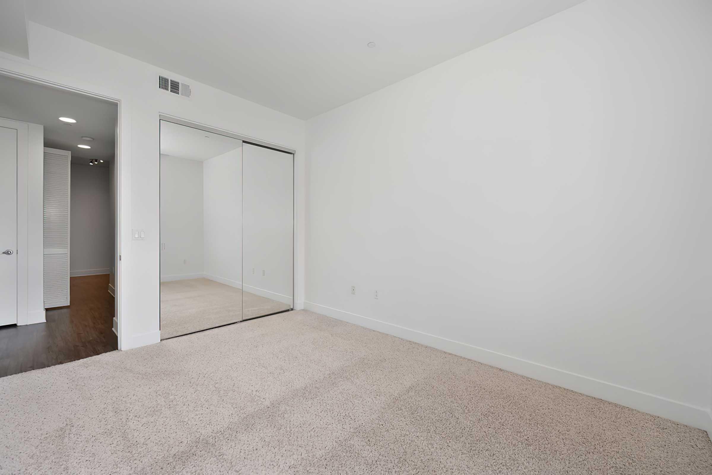 a room with mirrored closet doors