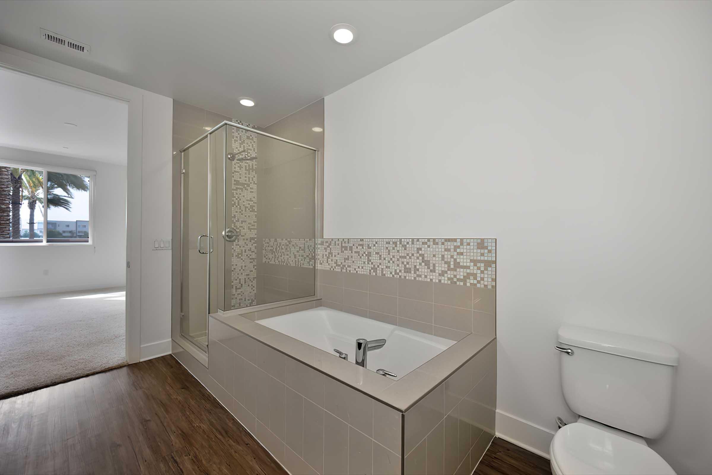 tiled tub and shower in the bathroom