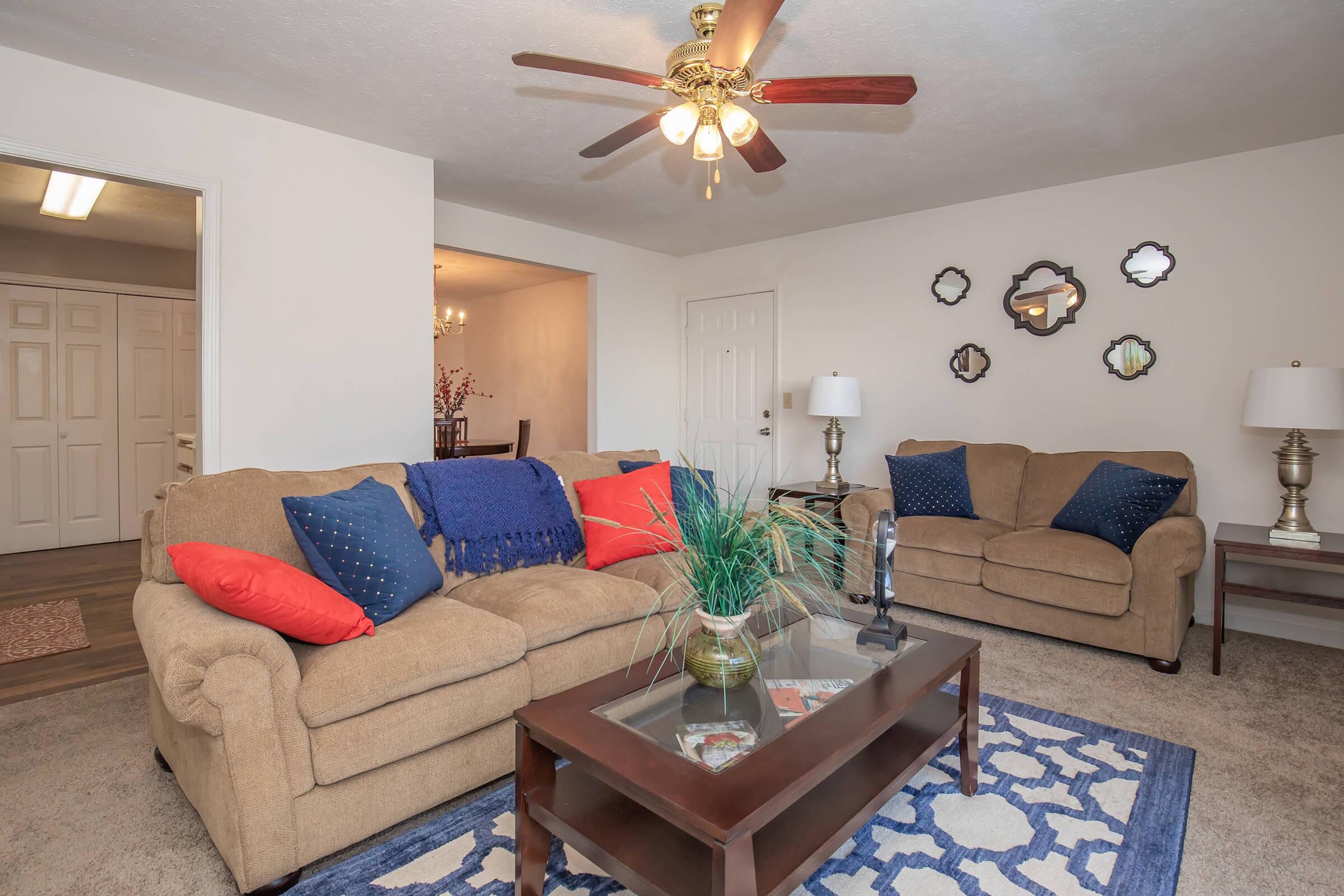 a living room filled with furniture and a rug