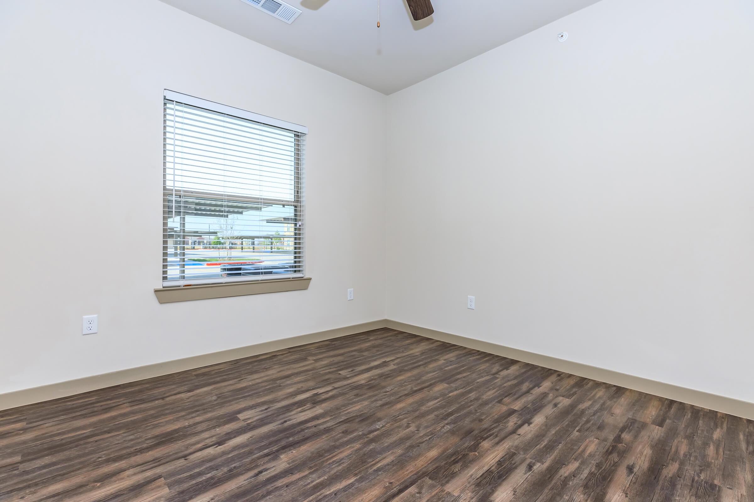 a bedroom with a wooden floor