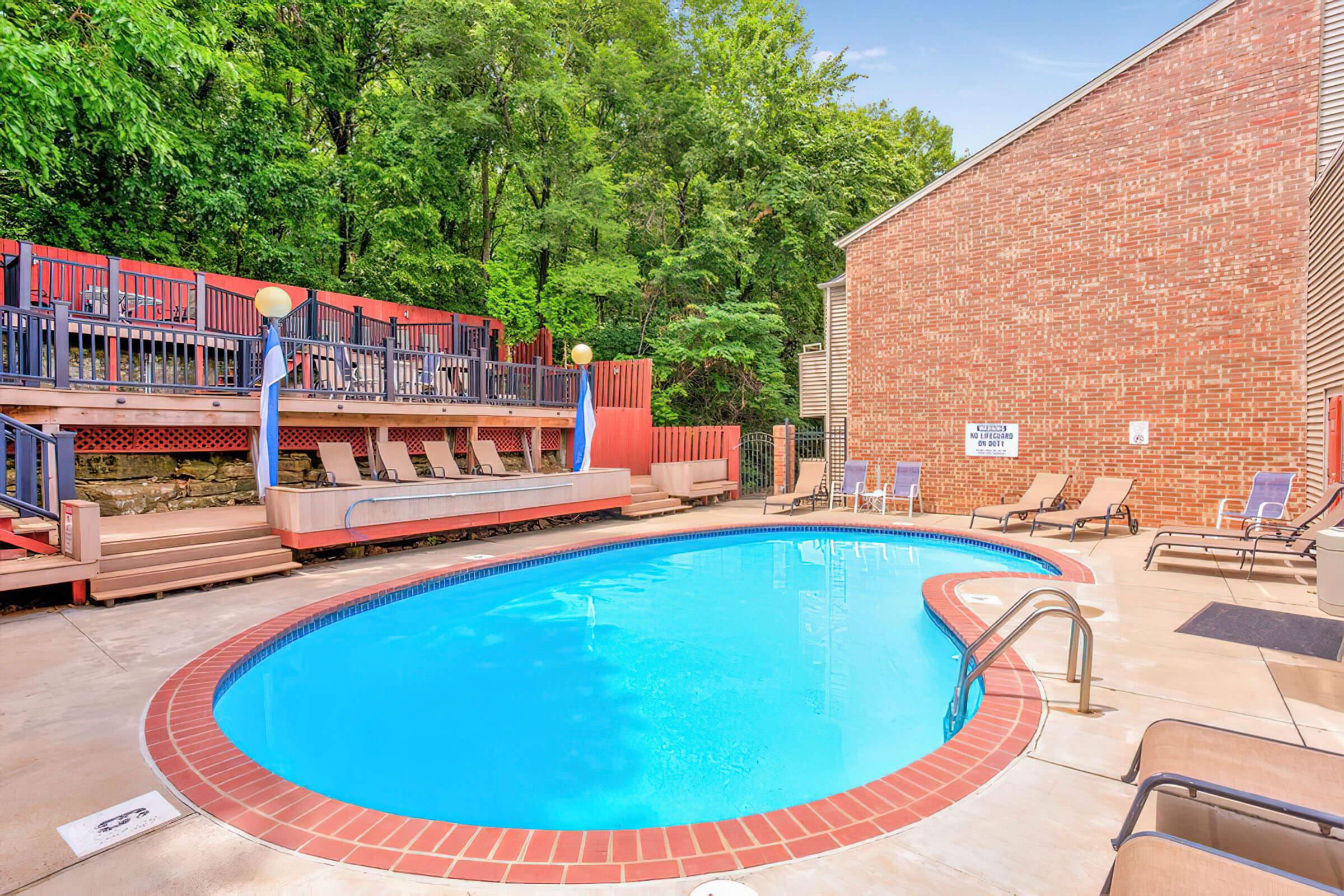Shimmering Swimming Pool with Poolside Lounge at Rainbow Ridge Apartments in Kansas City, Kansas