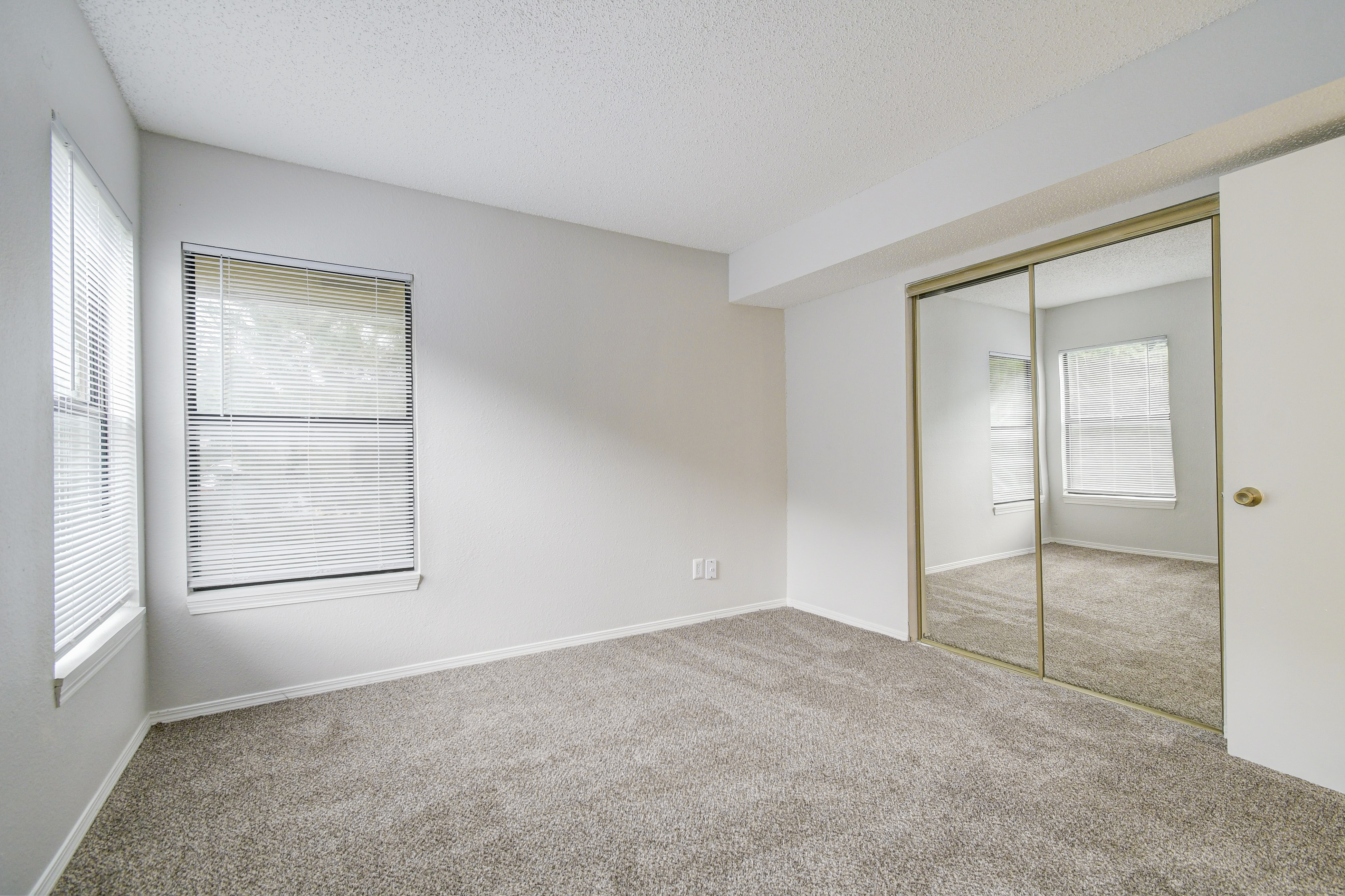 Oversized closet and fresh carpeting in bedroom at Rainbow Ridge Apartments in Kansas City, Kansas