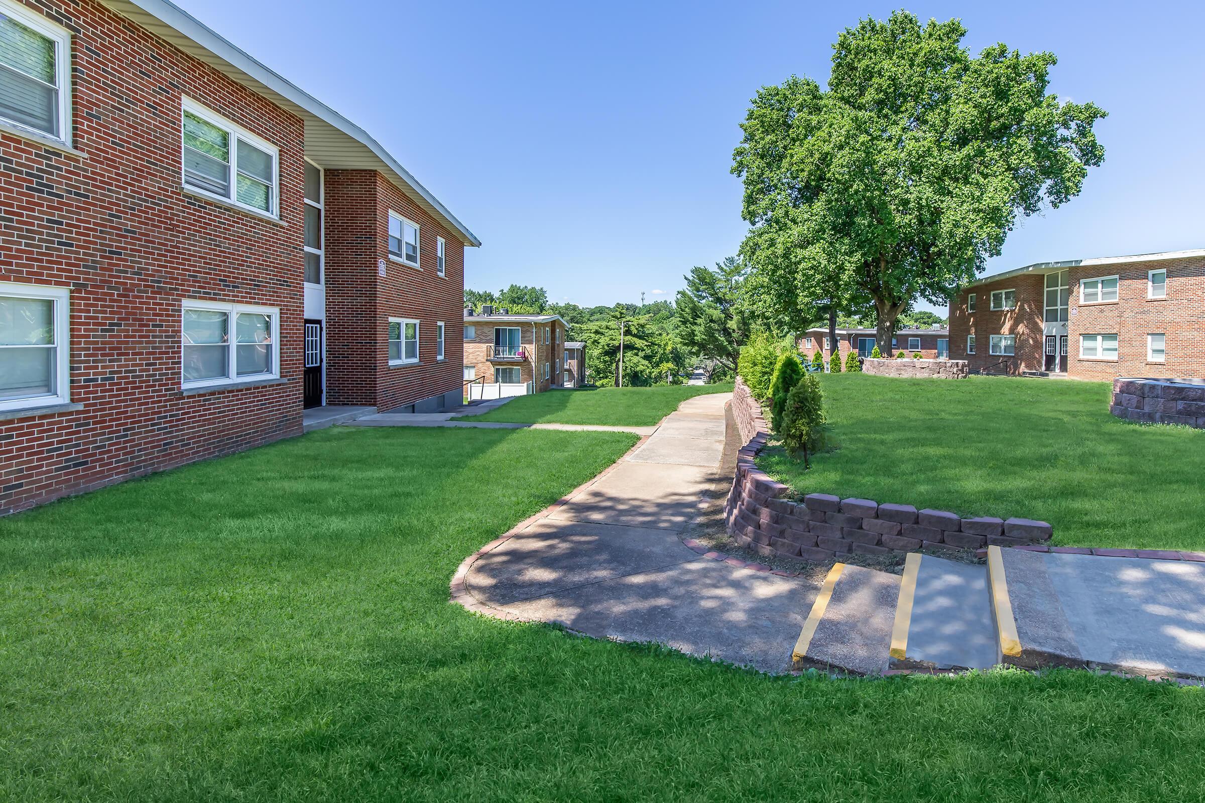 a large lawn in front of a brick building