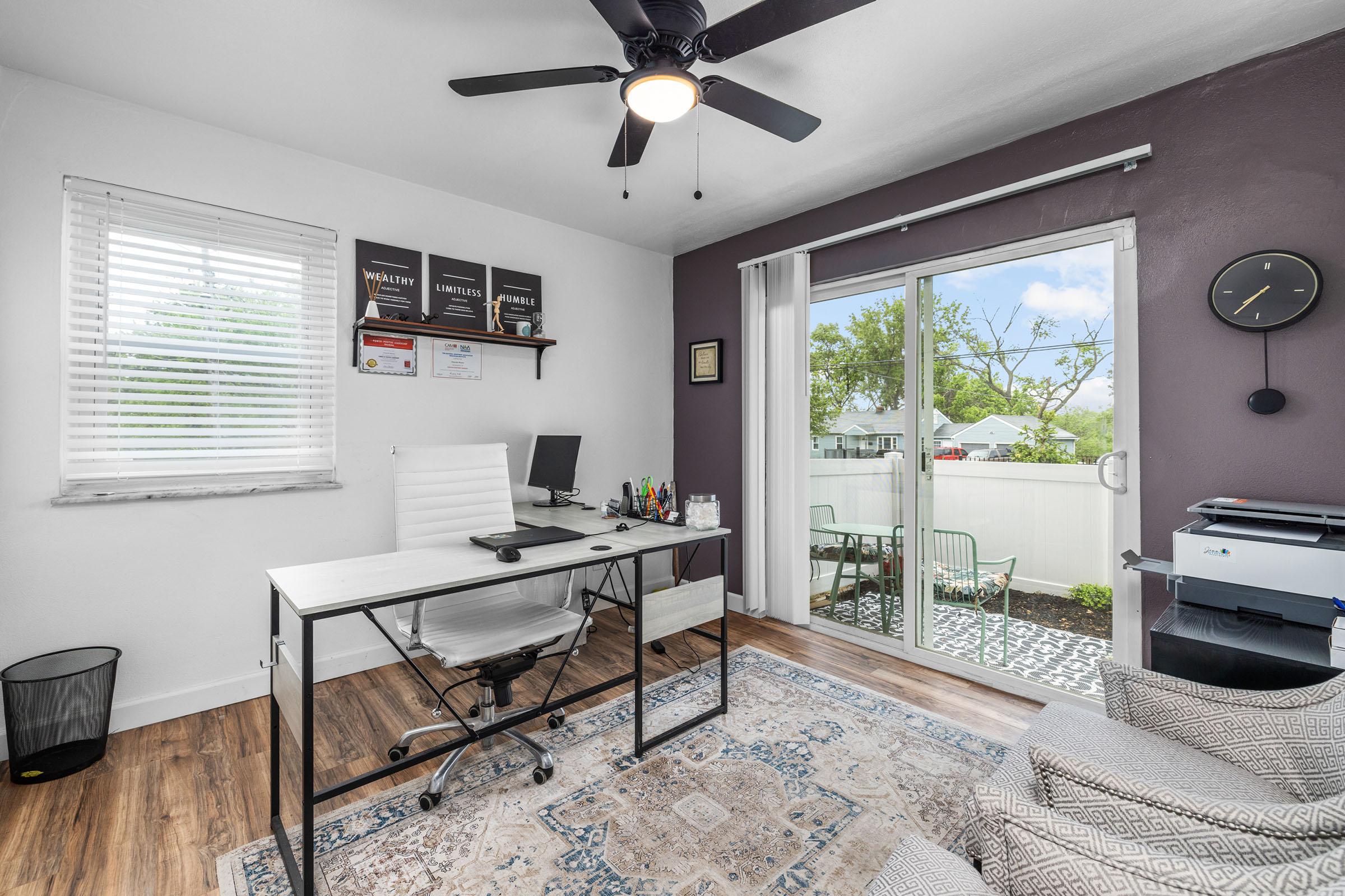 a living room filled with furniture and a large window