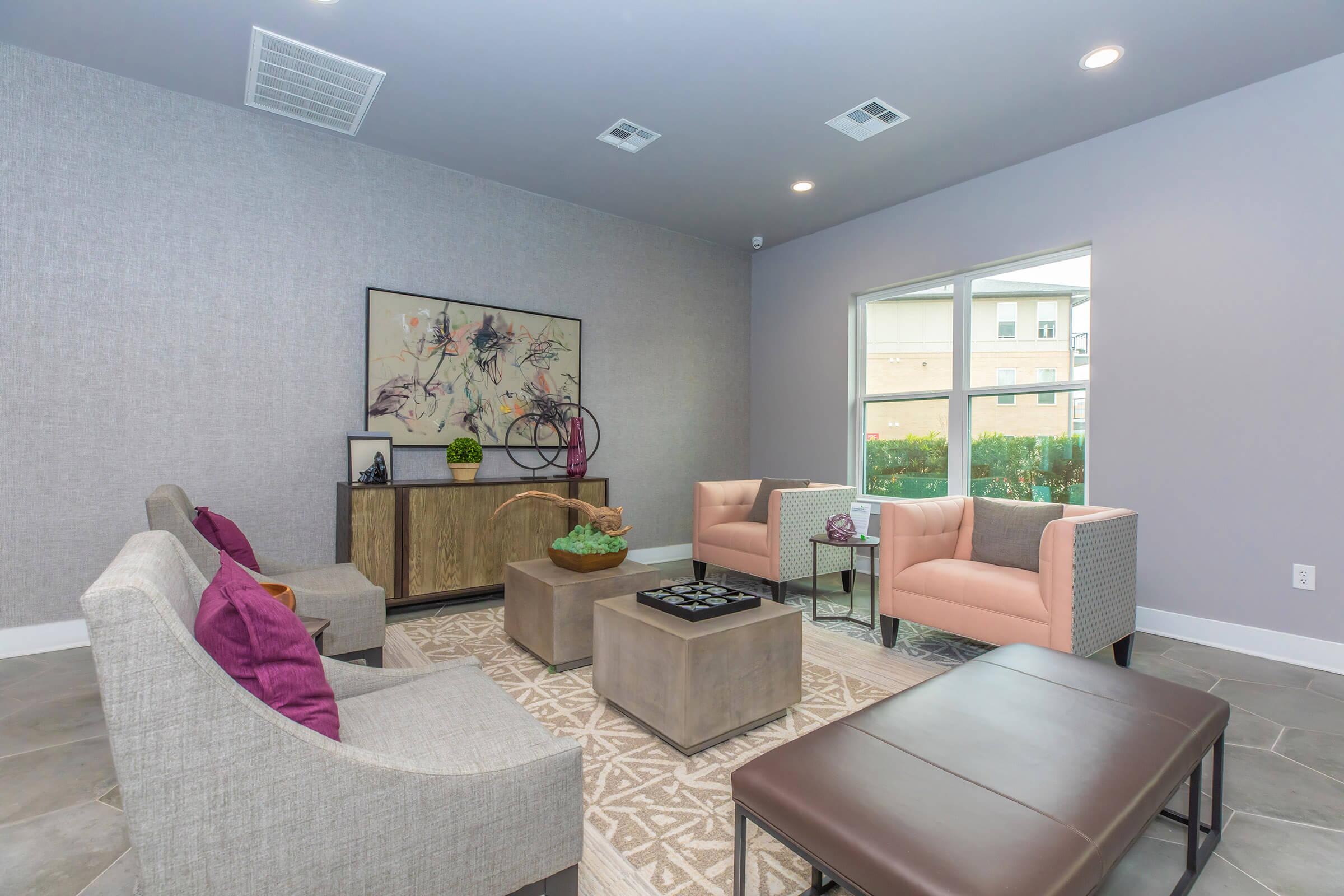 a living room filled with furniture and a large window
