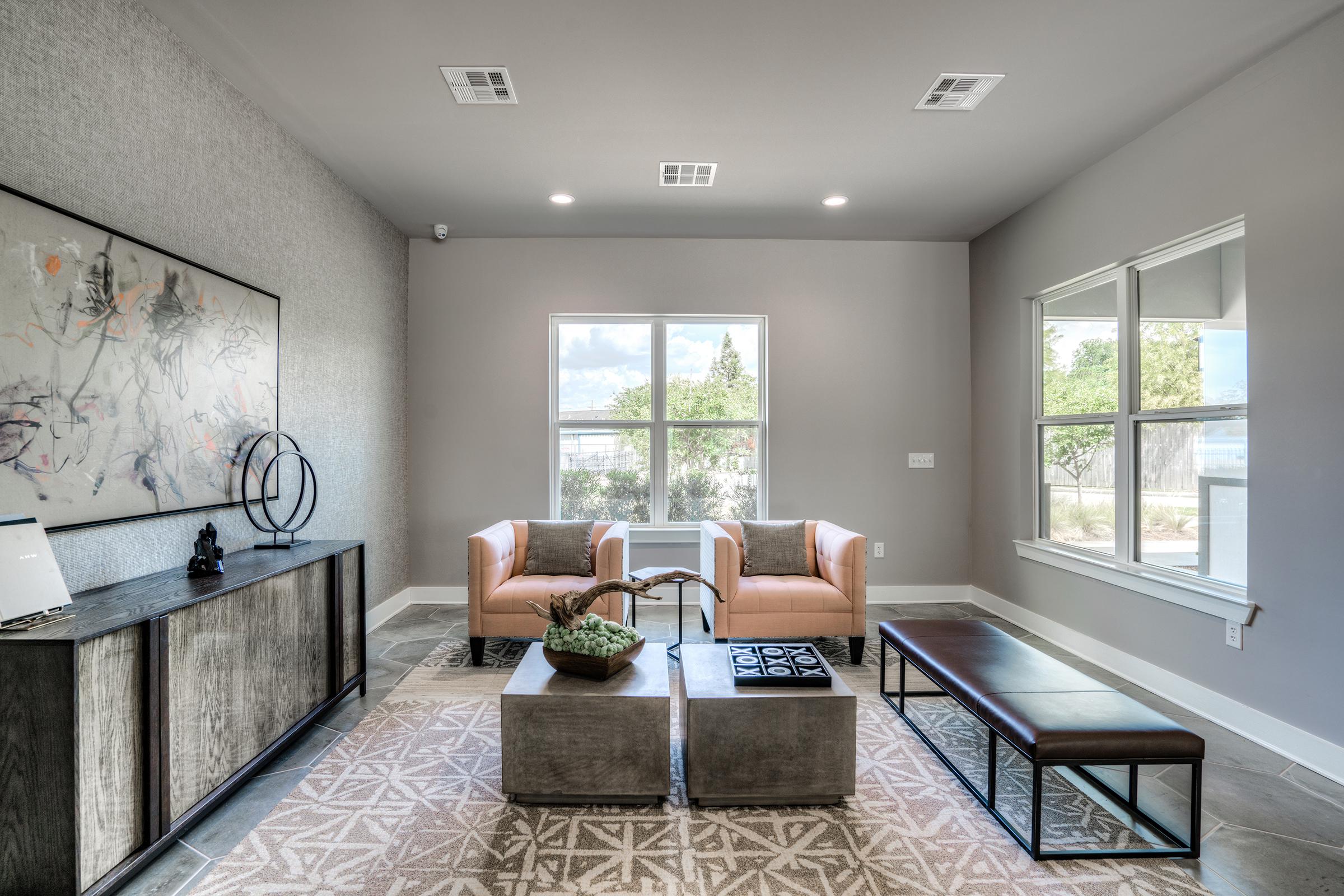 a living room filled with furniture and a large window