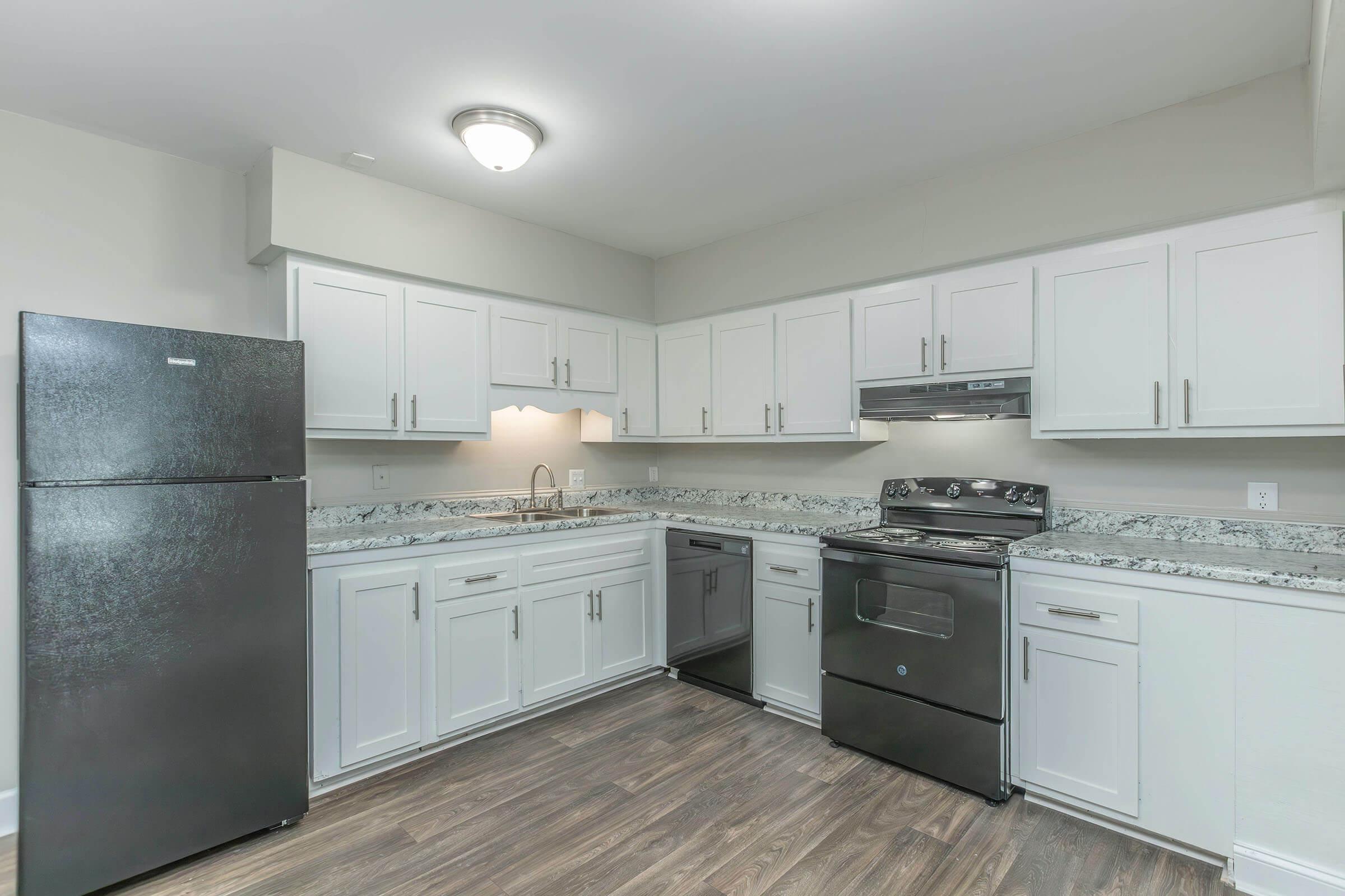 a kitchen with a stove sink and refrigerator