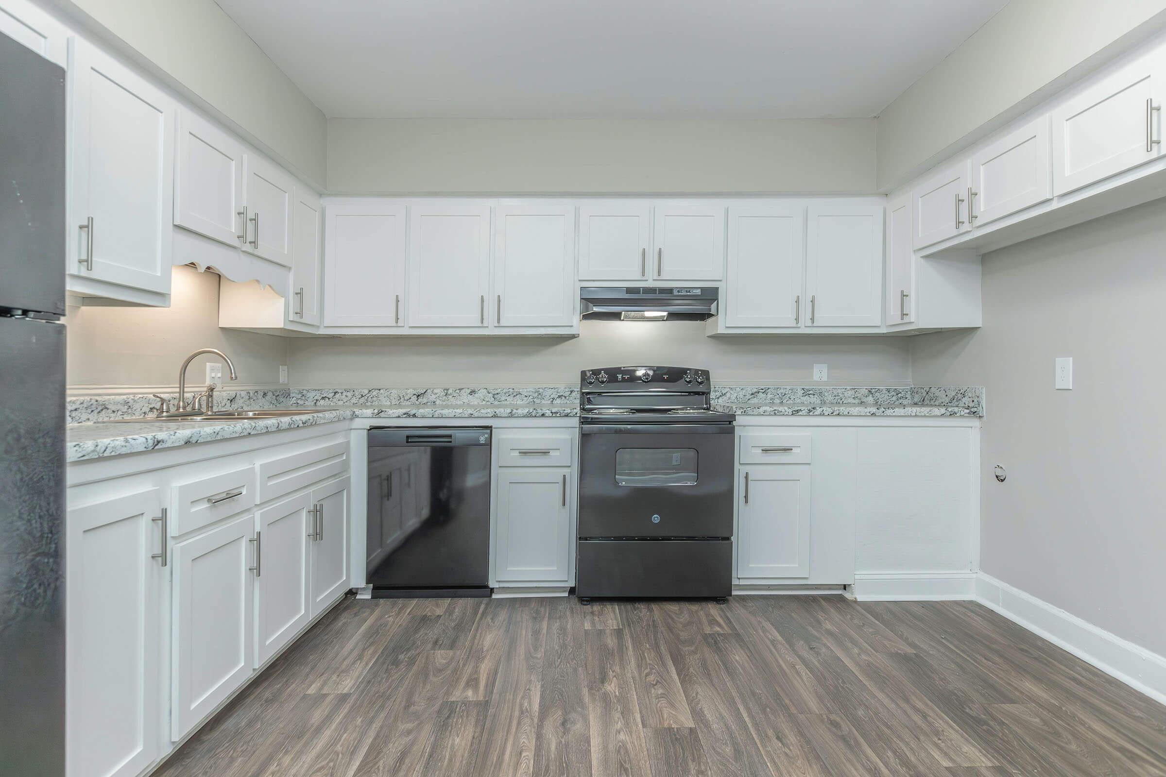 a kitchen with a stove and a refrigerator