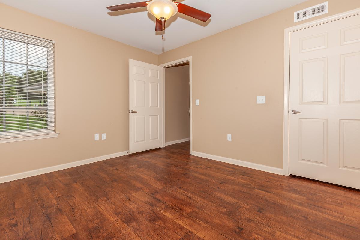 a large empty room with a wooden floor